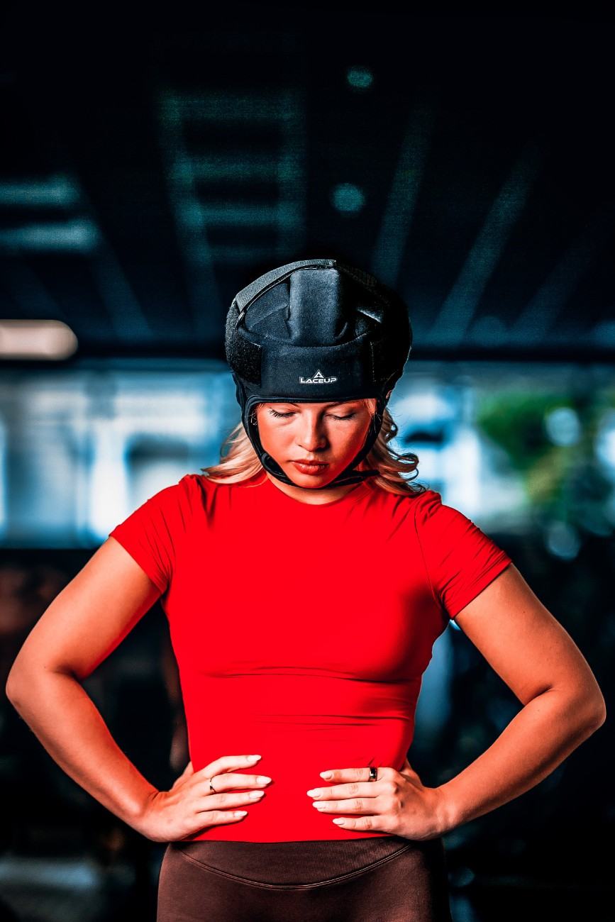 a woman wearing a red shirt and black hat