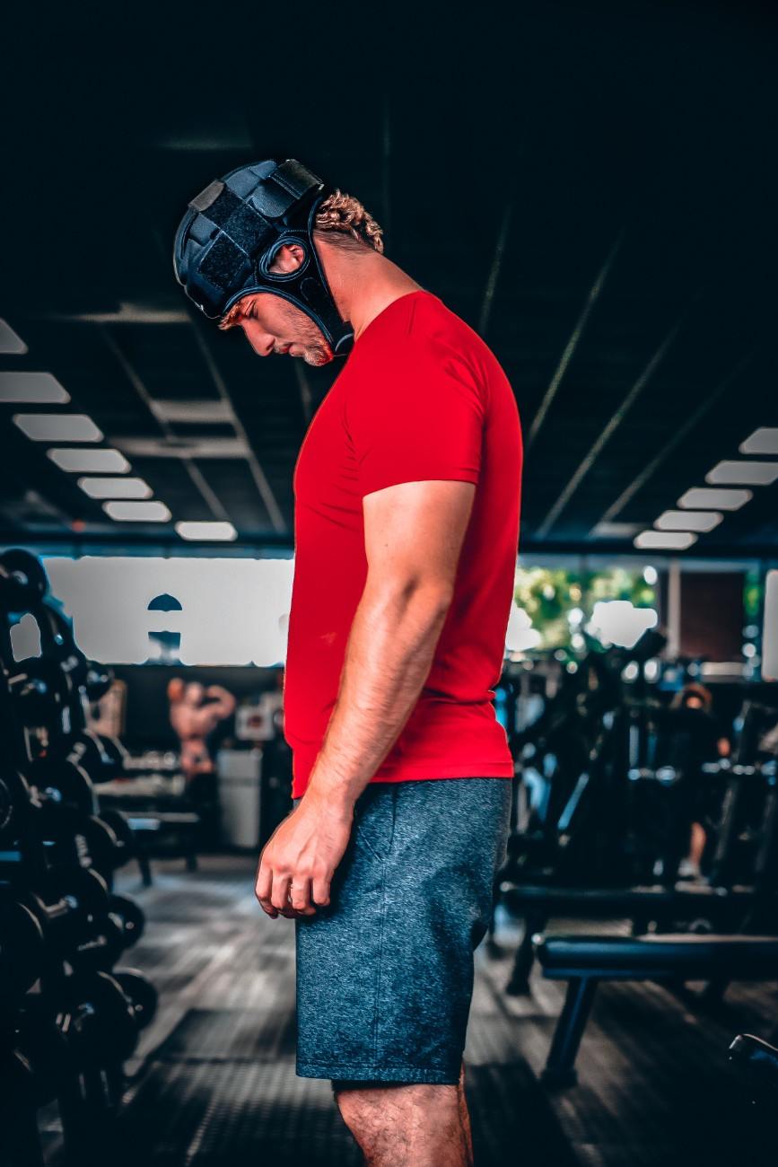 a man in a red shirt and black mask