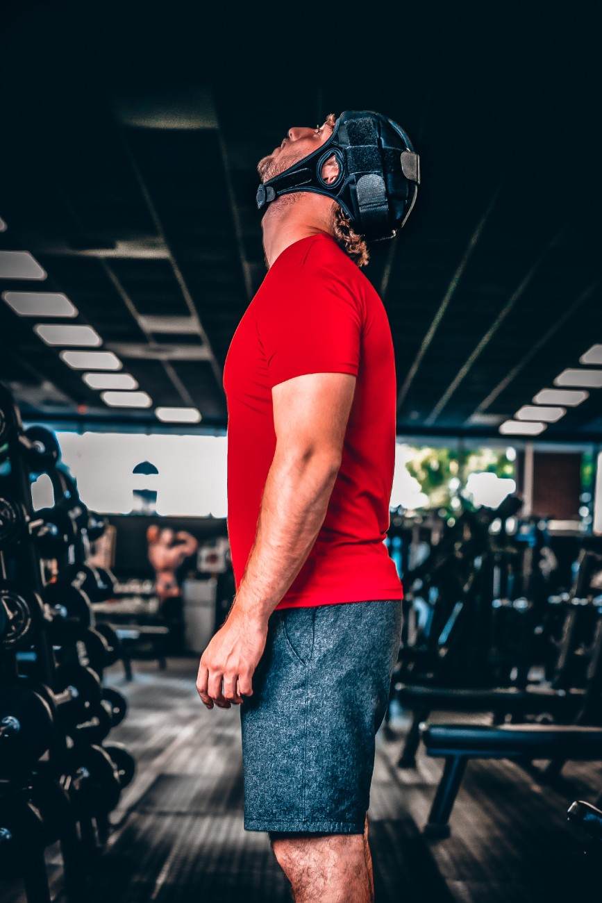 a man wearing a red shirt and a mask