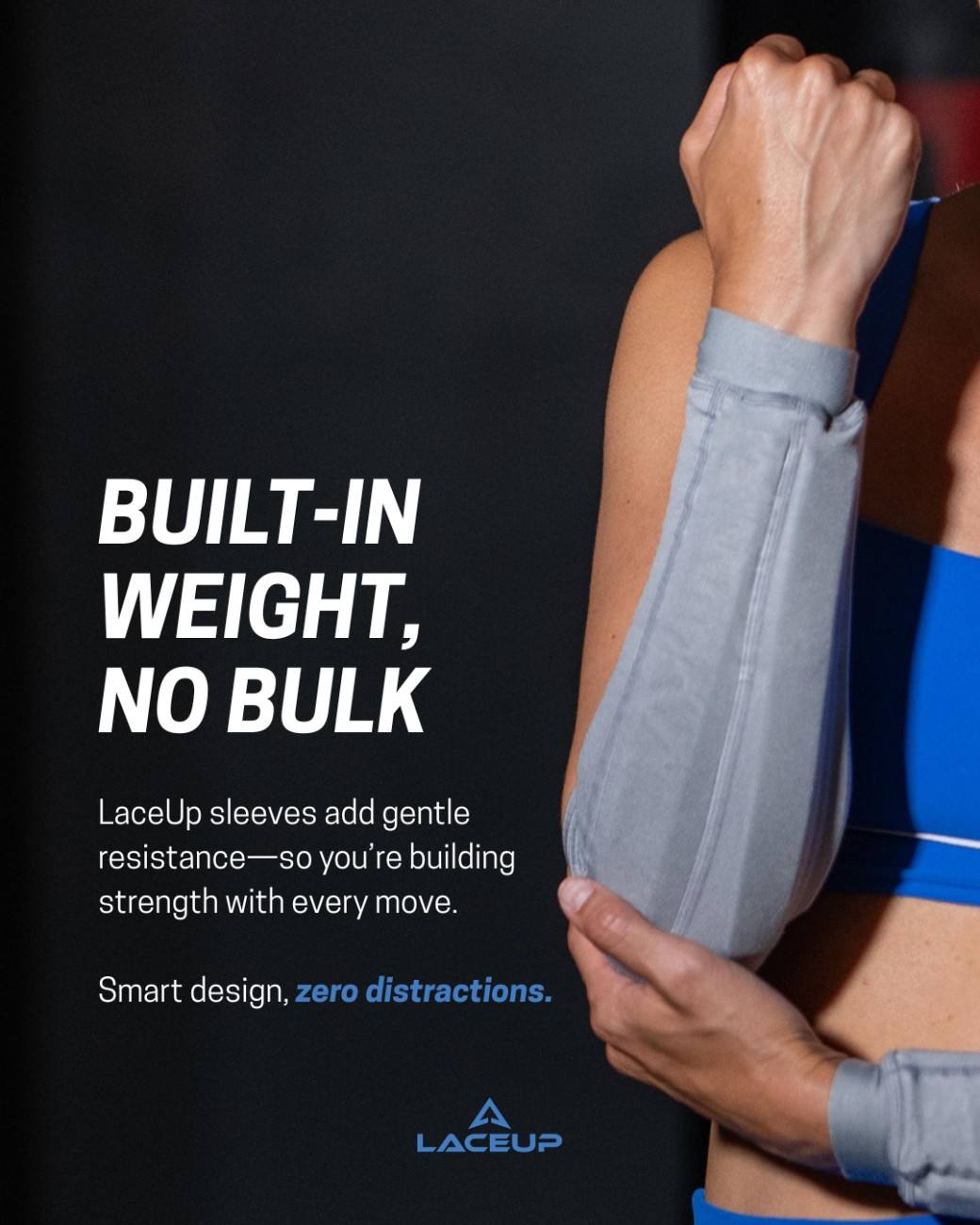 a woman wearing a blue sports garment and holding her arm up